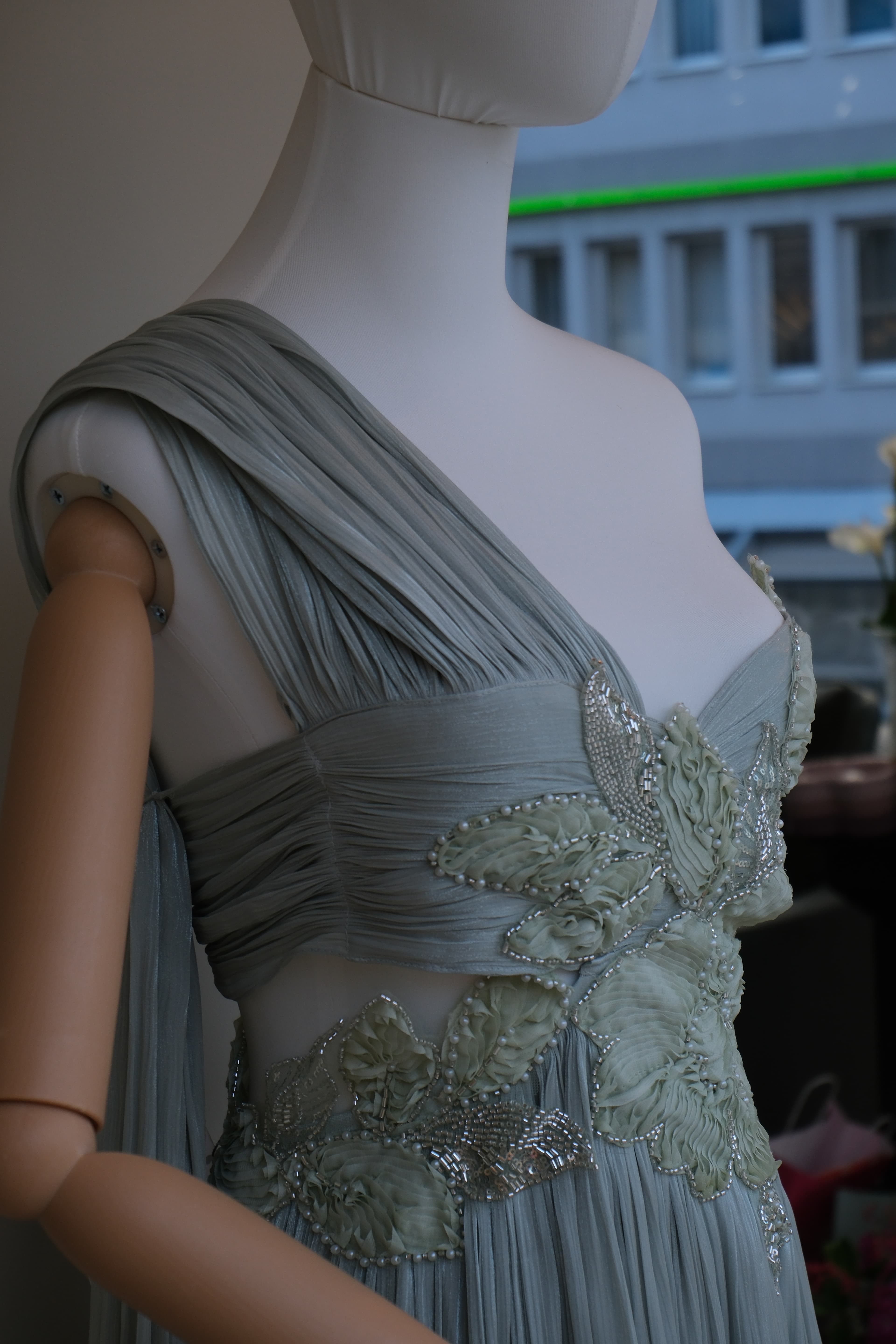 Hand-beaded floral embroidery on the pleated sage gown — RABEL Atelier